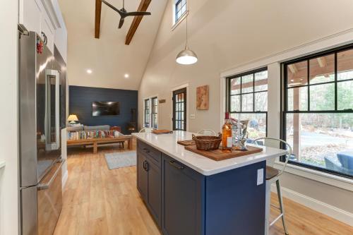 a kitchen with a large island in the middle of a room at Thistle Pond Cottage in Biddeford