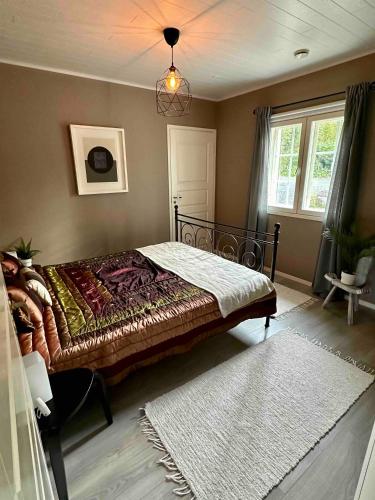 a bedroom with a large bed in a room at Villa Kesälä in Ylöjärvi