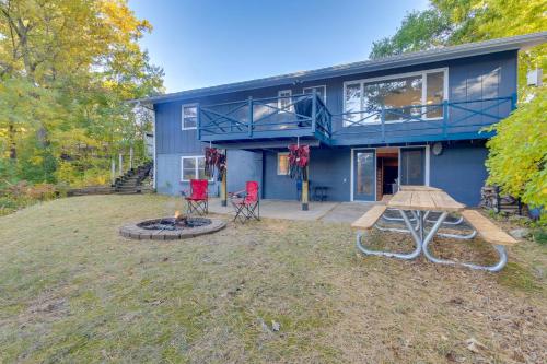 a blue house with a picnic table and two chairs at Antiquing and Fishing Riverfront Waupaca Home! in Waupaca