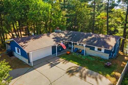 an overhead view of a blue house with a flag at Antiquing and Fishing Riverfront Waupaca Home! in Waupaca