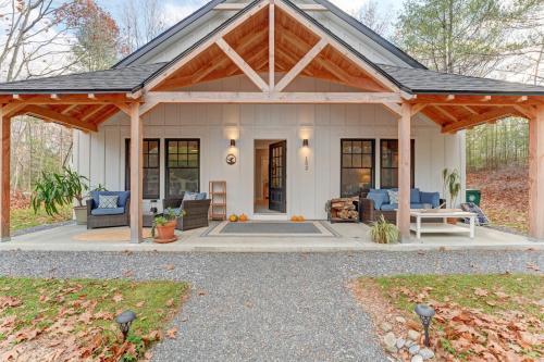 a home with a covered patio with a roof at Thistle Pond Cottage in Biddeford
