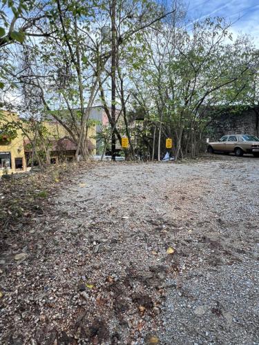 a parking lot with trees and a car parked at Spring Street Overlook in Eureka Springs