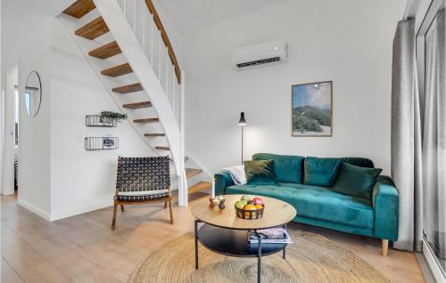 a living room with a blue couch and a table at Havnehusene, Lejl 40 in Slagelse