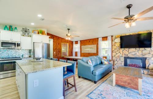 a kitchen and living room with a blue couch at Waterfront Home with Boat Dock and Slip in Old Town! in Old Town