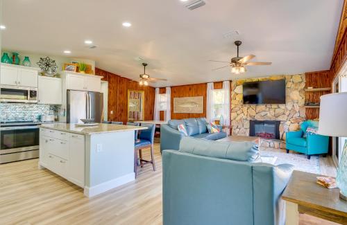 a kitchen and living room with a blue couch at Waterfront Home with Boat Dock and Slip in Old Town! in Old Town