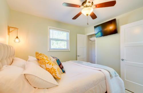 a bedroom with a ceiling fan and a bed with pillows at Waterfront Home with Boat Dock and Slip in Old Town! in Old Town