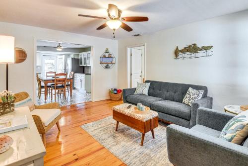 a living room with a couch and a table at Dog-Friendly Daytona Beach Cottage with Patio! in Daytona Beach