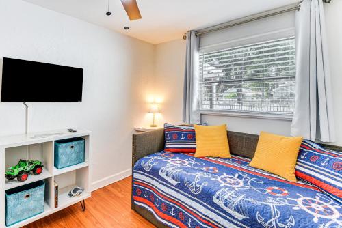 a bedroom with a bed and a flat screen tv at Dog-Friendly Daytona Beach Cottage with Patio! in Daytona Beach