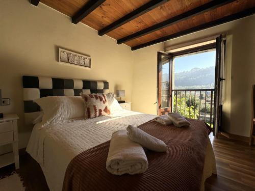 a bedroom with a large bed with a large window at Casa Las Hortensias 2 Pendueles in Llanes