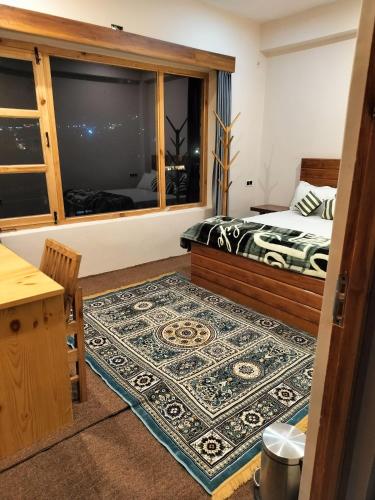 a bedroom with a bed and a window at Gawa Residency in Leh