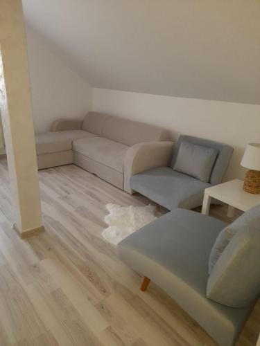 a living room with a couch and a table at Apartament CASA MIRIAM in Lugoj