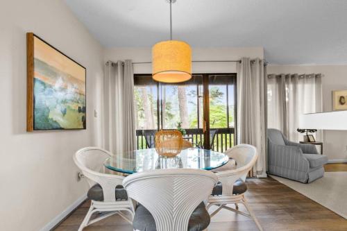 a dining room with a glass table and chairs at Pinehurst Choice in Pinehurst