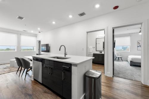 a kitchen with a sink and a living room with a bed at The Nomad ATL in Atlanta