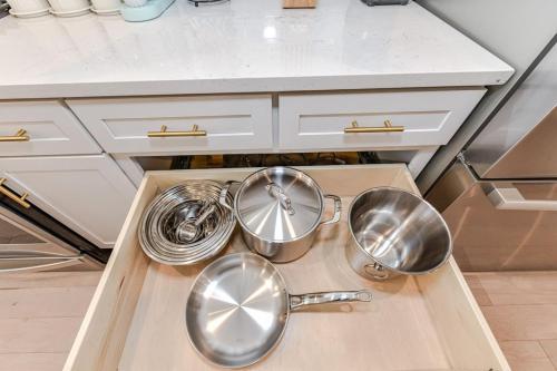 a kitchen with three pots and pans on a counter at On the Move in Plaza Midwood in Charlotte