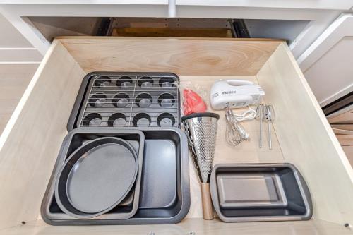 a drawer filled with kitchen utensils in a cabinet at On the Move in Plaza Midwood in Charlotte
