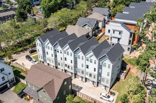 an overhead view of a large white building with gray roofs at On the Move in Plaza Midwood in Charlotte