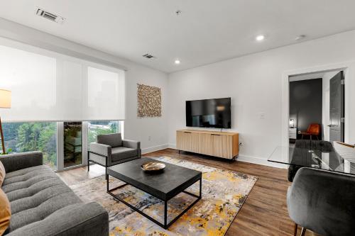 a living room with a couch and a tv at The Nomad ATL in Atlanta