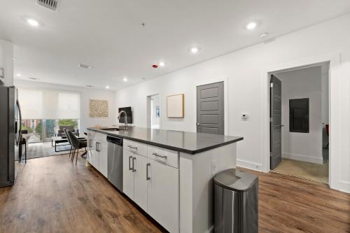 a kitchen with white cabinets and a black counter top at The Nomad ATL in Atlanta