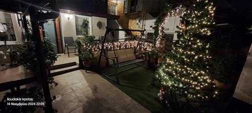 a christmas tree on a balcony with lights at Zoe garden home in Spáta