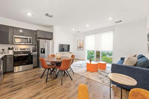 a kitchen and living room with a table and a blue couch at The Nomad ATL in Atlanta