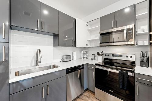 a kitchen with stainless steel appliances and a sink at The Nomad ATL in Atlanta
