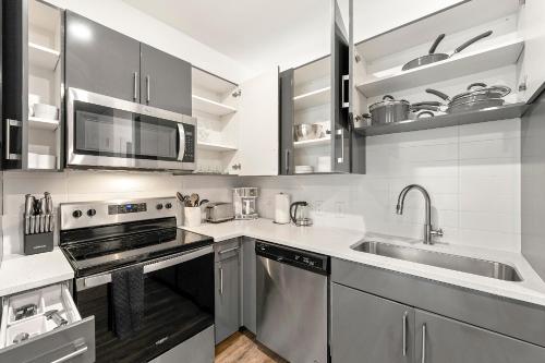 a kitchen with a sink and a stove at The Nomad ATL in Atlanta