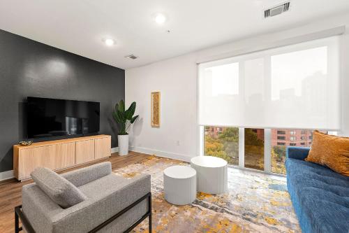 a living room with a couch and a tv at The Nomad ATL in Atlanta