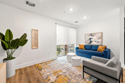 a living room with a blue couch and a chair at The Nomad ATL in Atlanta