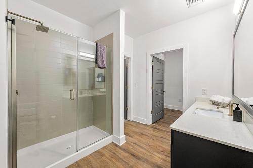 a white bathroom with a shower and a sink at The Nomad ATL in Atlanta