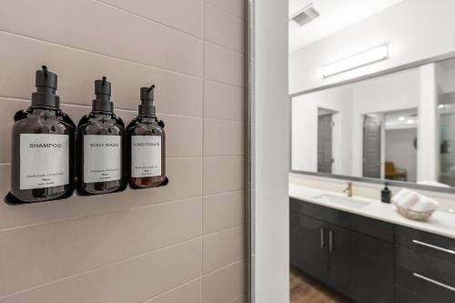 a bathroom with three bottles of wine on a wall at The Nomad ATL in Atlanta