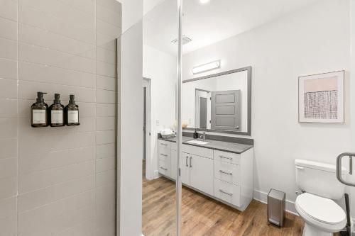 a bathroom with a sink and a toilet and a mirror at The Nomad ATL in Atlanta