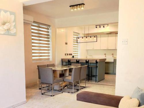 a dining room and kitchen with a table and chairs at Family Stylish &Modern 3bedr Gem in Gibraltar