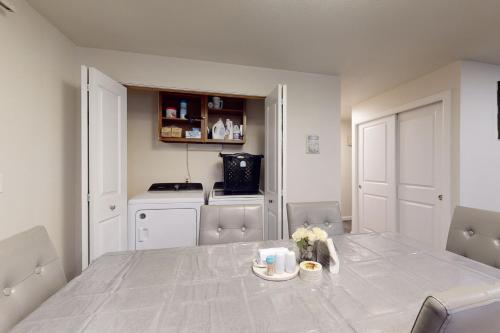 a dining room with a table and a kitchen at Port Orchard Retreat in Port Orchard