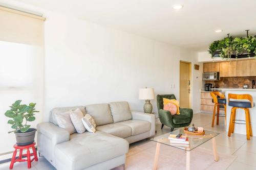 a living room with a couch and a table at Mistico Serenity Shores at Nautilus in Playa Hermosa