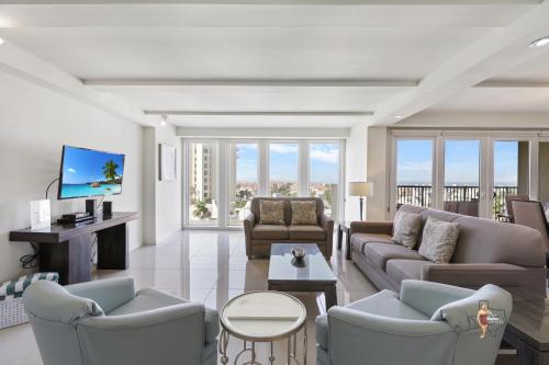 a living room with a couch and chairs and a tv at Bahia Mar-Solare Tower, Beachfront Resort with Two Pools in South Padre Island