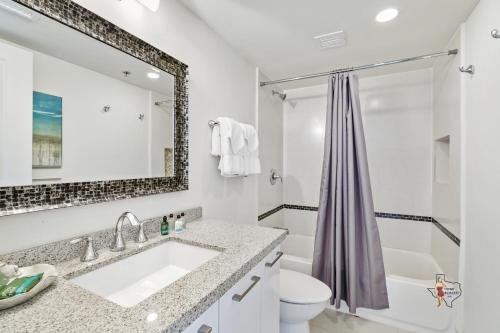 a bathroom with a sink and a shower at Bahia Mar-Solare Tower, Beachfront Resort with Two Pools in South Padre Island