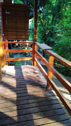 a wooden porch of a cabin with a fence at Cabañas Alegria Cajón del Maipo in San José de Maipo