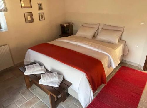 a bedroom with a large bed and a red rug at Terra Petra Villa at Psari Trikolonon Gortynia in Psárion
