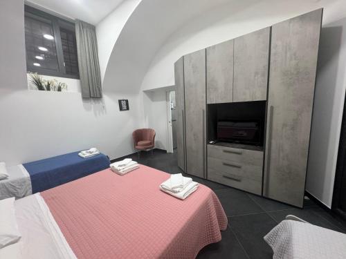 a room with a bed with a table and a tv at A' casa mij in Naples