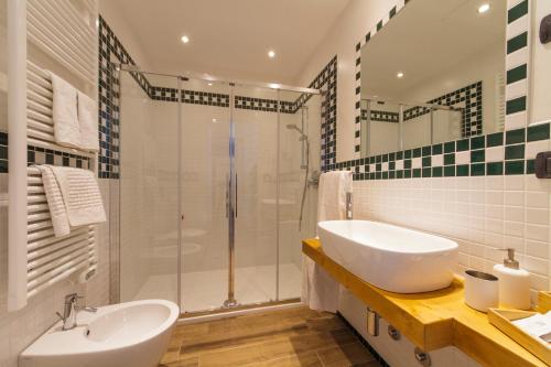 a bathroom with a sink and a shower at Locanda Ai Due Orsi in Milan