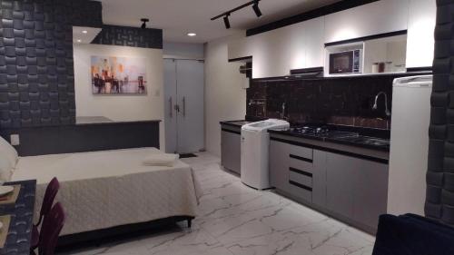 a large kitchen with a bed in a room at Studio Pelourinho, Salvador in Salvador