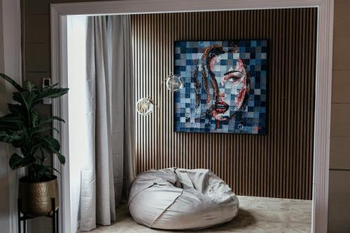 a white bean bag chair in a room with a painting at Huset Vårt - Bed and Breakfast in Hornindal