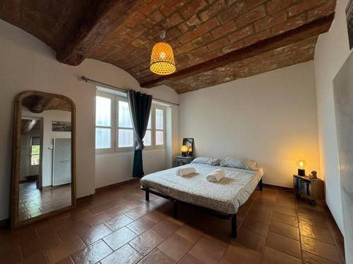 a bedroom with a bed and a large window at La casa terracotta in Claira