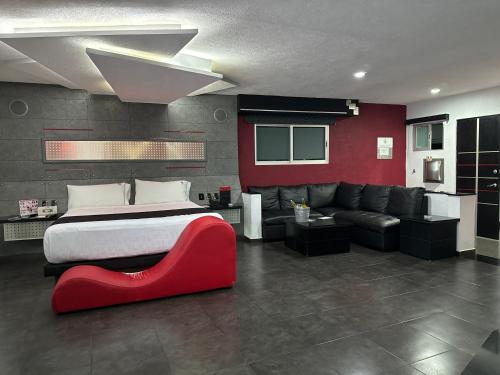 a bedroom with a large bed and a red couch at Kuboz Motor Hotel (Motel y Hotel) in Guadalajara