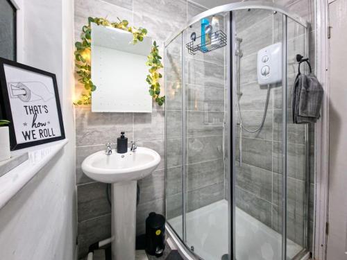a bathroom with a shower and a sink at The Cave in Coventry