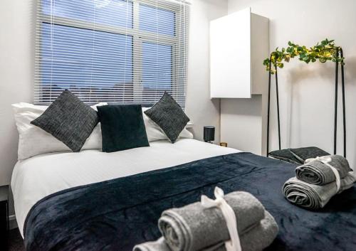 a bedroom with a large bed with stuffed animals on it at The Cave in Coventry