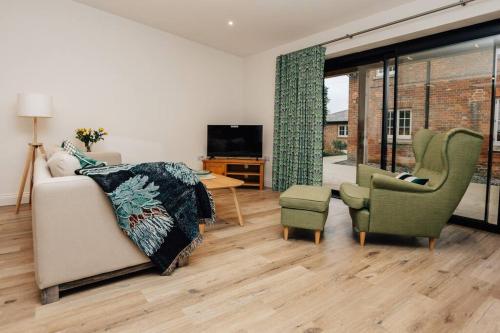 a living room with a couch and two chairs at Cart Shed 1 in Oxford