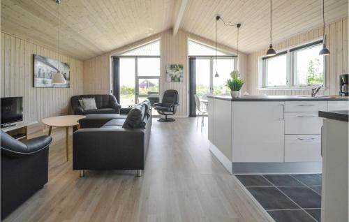 a kitchen and living room with a couch and a table at Three-Bedroom Holiday Home In Tarm in Tarm