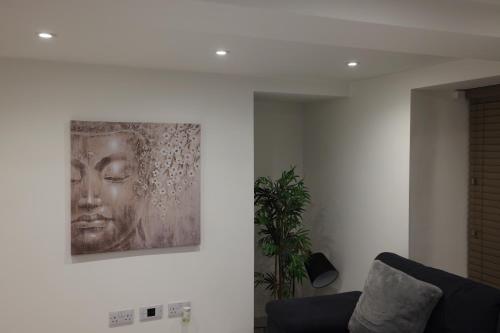 a painting hanging on a wall in a living room at Stylish 1 Bed Apartment in Bicester Town Centre in Bicester