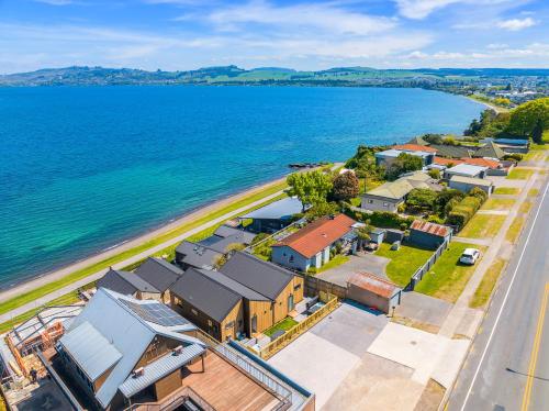 an aerial view of a small town next to the water at Stunning Lake Views Spa Pool in Taupo